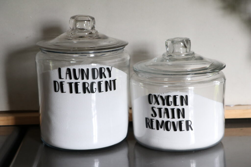 glass jars labeled for laundry detergent and oxygen stain spray