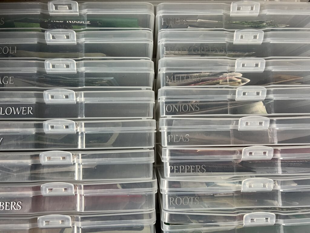 photo cases full of seed packets labeled with silver plant type names