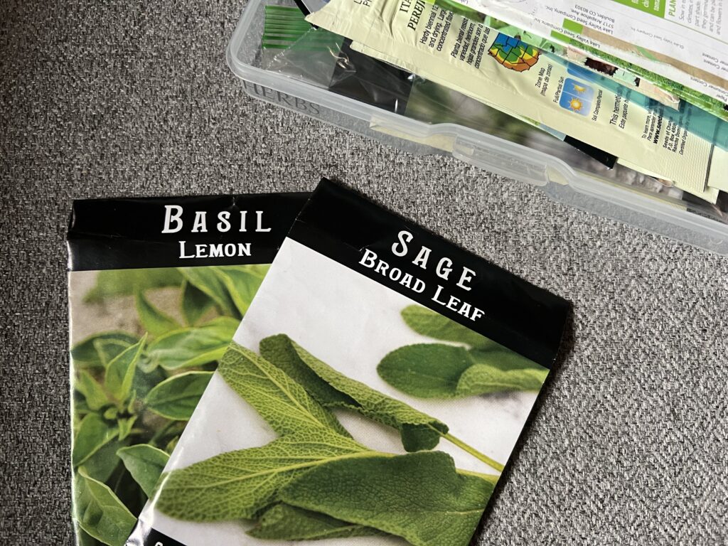 Basil and Sage seed packet next to seed storage case